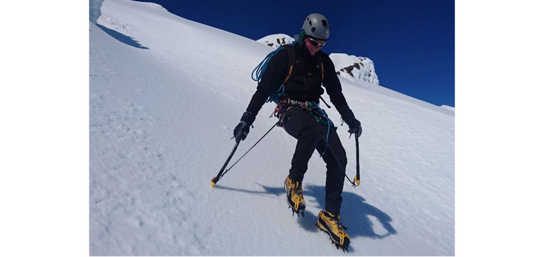 Mountaineer descending steep slope