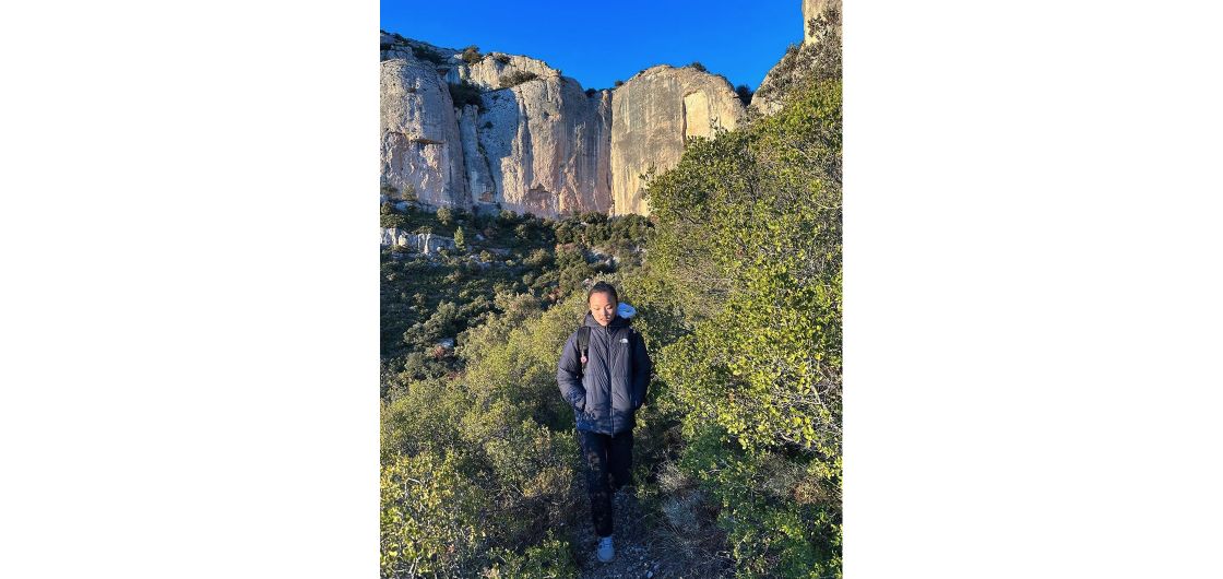 Climber below cliffs