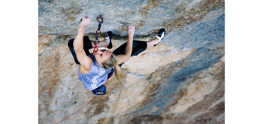 Femalew rock climber on terrifically hard route