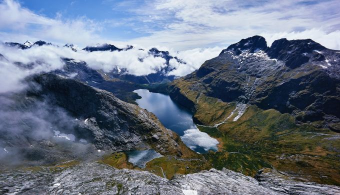 A view of a lake in a basin surrounded by steep mountains