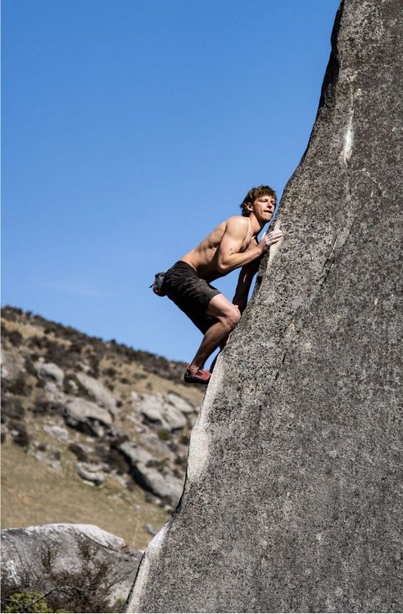 boulderer on limestone boulder