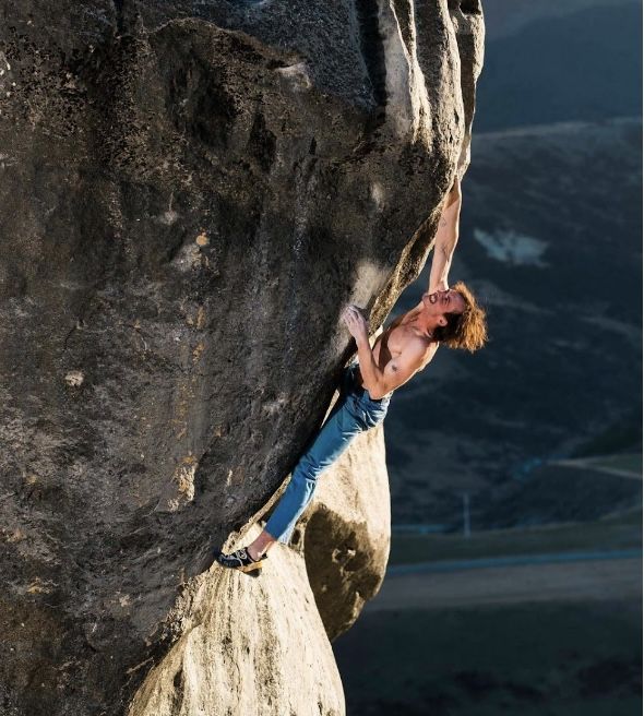 boulderer on limestone boulder