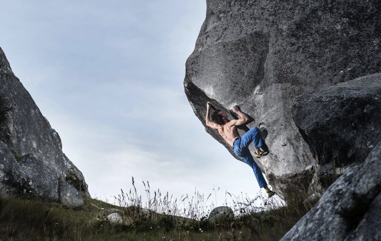 boulderer on limestone boulder