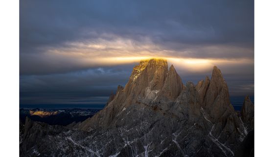 Clouds and sun around a mountain top
