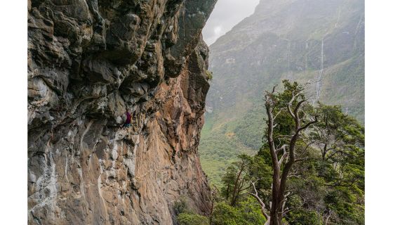 Climber on steep granite in fiords