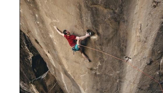 Climber on crazy hard trad route