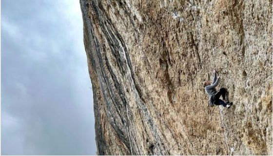 Female climber on steep rock.