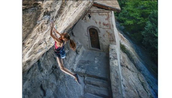 Female climber on steep rock.