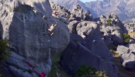 Climber on tall boulder