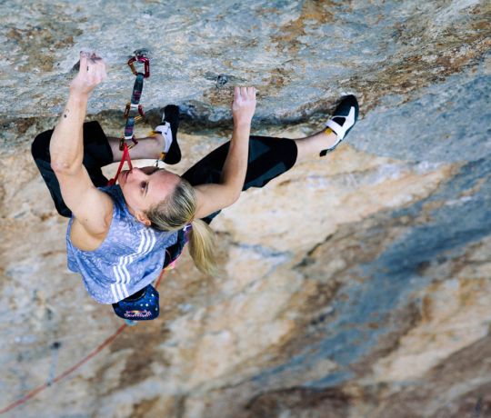 Femalew rock climber on terrifically hard route